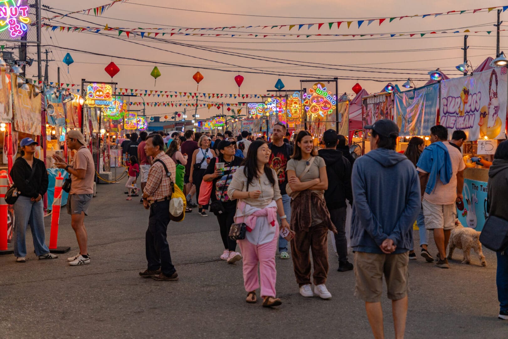 Richmond, Vancouver, BC, Canada-September 8, 2024: People walking around the local night market in a Chinese neighborhood at twilight.